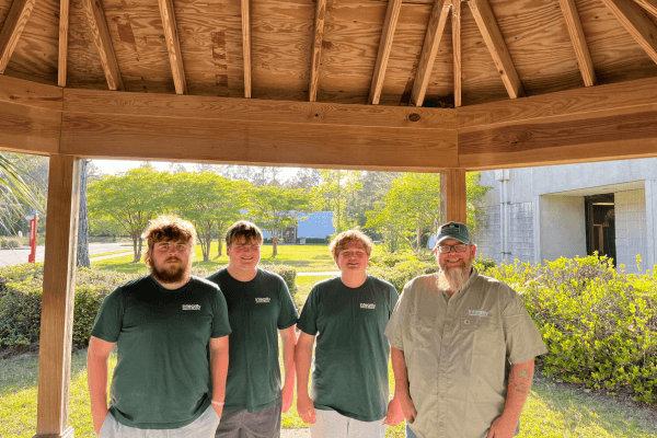 Integrity Contracting Solutions crew standing together under a custom-built wood pavilion