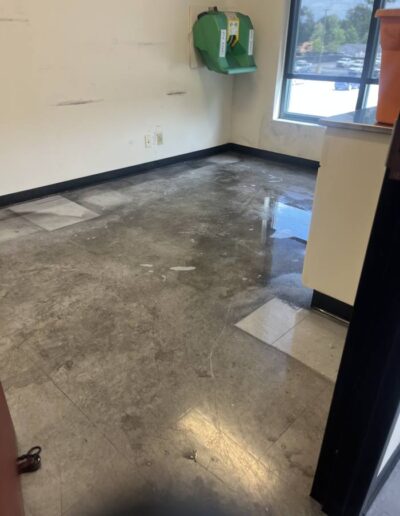 Tan tile floor midway through cleaning with wet mopped sections in an office room