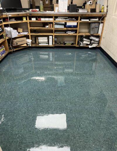 Glossy polished green terrazzo floor in a storage room with supply shelving