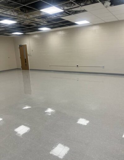 Freshly polished concrete floor in an empty commercial space with cinder block walls
