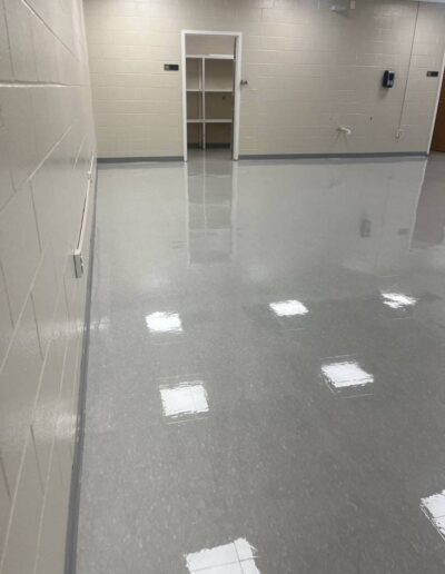 Polished concrete floor in a storage room with empty shelving unit