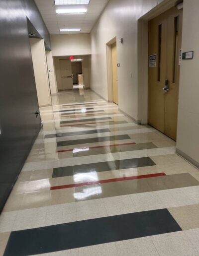 Glossy terrazzo tile floor in an office corridor with wooden doors after floor care service