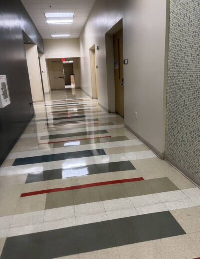Sparkling clean commercial hallway with polished patterned tile floor