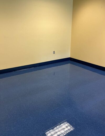 Clean, polished blue tile floor in a commercial room after professional floor cleaning